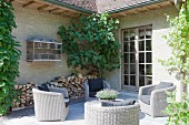 Grey wicker armchairs in pleasant seating area outside house