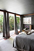 Bedrooms in shades of gray and with floor-to-ceiling patio doors