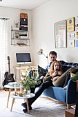 Young couple on blue sofa in retro living room