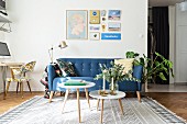 Blue retro sofa, standard lamp and side table in living room