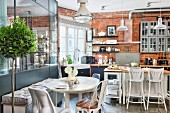 Mixture of industrial, vintage and modern styles in kitchen-dining room of loft apartment