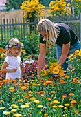 Mother and daughter picking flowers