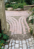 Garden path with ribbons of red clinker
