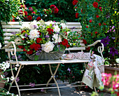 Garden bench with climbing rose 'Flammentanz', basket with arrangement