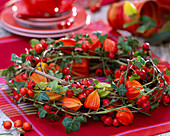 Wreath made of roses (rosehip), physalis (lanterns flowers), hedera (ivy)