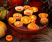 Cucurbita eroded (pumpkin), with candles floating in glass bowl