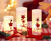 Glasses with parchment paper as lanterns with ribbon