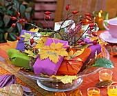 Gifts autumn decorated with Acer (maple leaves)