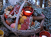 Filled wicker basket with hoarfrost with red glass wind lights