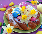 Easter nest made of yeast dough with Narcissus (Daffodil) flowers