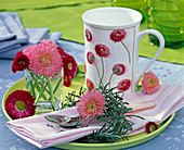 Bellis (Daisies) in small vase and on pink napkin