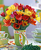Tulipa bouquet in green vase with ribbon, wreath of Buxus