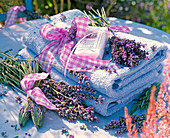 Lavandula as bottles and bouquet on blue towels