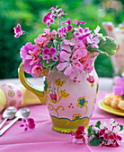 Bouquet made of various pelargonium (geranium) in milk jug
