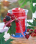 Rubus (blackberry) on lantern with red candle