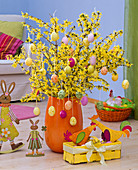 Forsythia (gold bells) bouquet decorated in orange vase