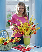Bouquet of forsythia branches and stucked tulips