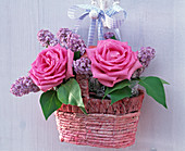 Rose, syringa in a small woven handle basket