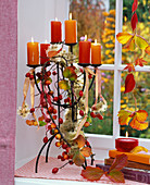 Candlestick with rosehips, malus, clematis