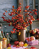 Bouquet of malus, pile with dishes towels, bottles