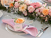 Festive table decoration with inserted garland