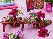 Deco shoes with bougainvillea and dahlia in small glass bottles