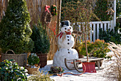 Winter terrace with snowman and sledge