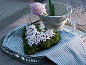 Moss heart with flowers of Hyacinthus on metal tray