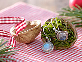 Moss-filled bowl of Juglans (walnut) as a gift wrap