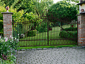 Garden view through wrought-iron gate