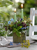 Candle arrangement with herbs in metal pot