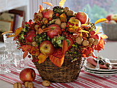 Autumn bouquet with apples, nuts, leaves and hydrangea