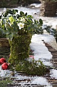 Moss boots with Helleborus niger (Christmas rose), red tree balls