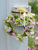 Heart of herbal flowers on the door handle