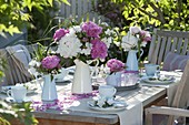 Pink-white peonies - table decoration on the terrace