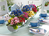 Primrose table decoration with planted zinc gutters