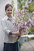 Girl with a Prunus sargentii 'Accolade' bouquet