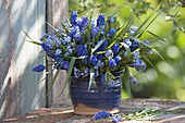 Blue spring bouquet in rustic vase