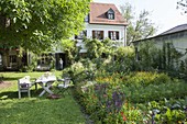 Colourful garden with summer flowers and vegetables