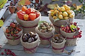 Autumn fruits in clay pots with plucking