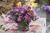 Autumn bouquet in a vase covered with bark