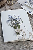 Greeting card frame with pressed forget-me-not
