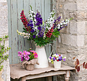 THE Garden AND PLANT COMPANY, Hatherop Castle, Cirencester, Gloucestershire: JUG with LUPINS, HESIAN Pot of Double COSMOS, PALE of Mixed Sweet PEAS