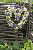 Heart-shaped wreath of camomile (Matricaria chamomilla) and flowers