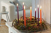 Wreath made of natural materials with candles on zinc