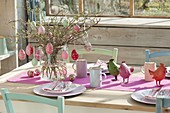 Easter table in the winter garden, bouquet of branches of Amelanchier