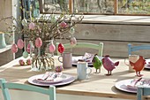 Easter table in the winter garden, bouquet of branches of Amelanchier