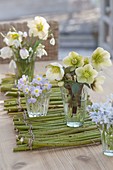 Small Helleborus niger bouquets on mat made of branches