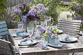Lilac table decoration with light blue dishes