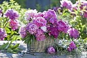 Paeonia (peony) arrangement with grasses in the basket